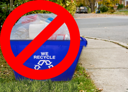 An example of what NOT to do: Recyclables are bagged up inside of an overflowing curbside recycling bin.