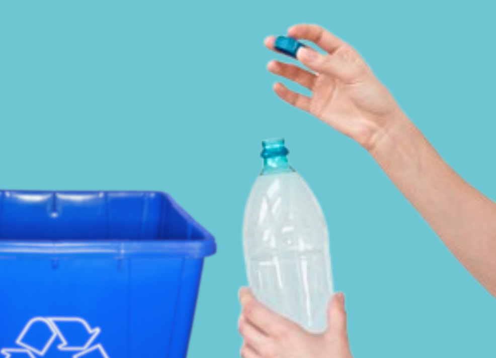 Hands holding a plastic water bottle replace the plastic cap back on the plastic bottle near a recycling bin.