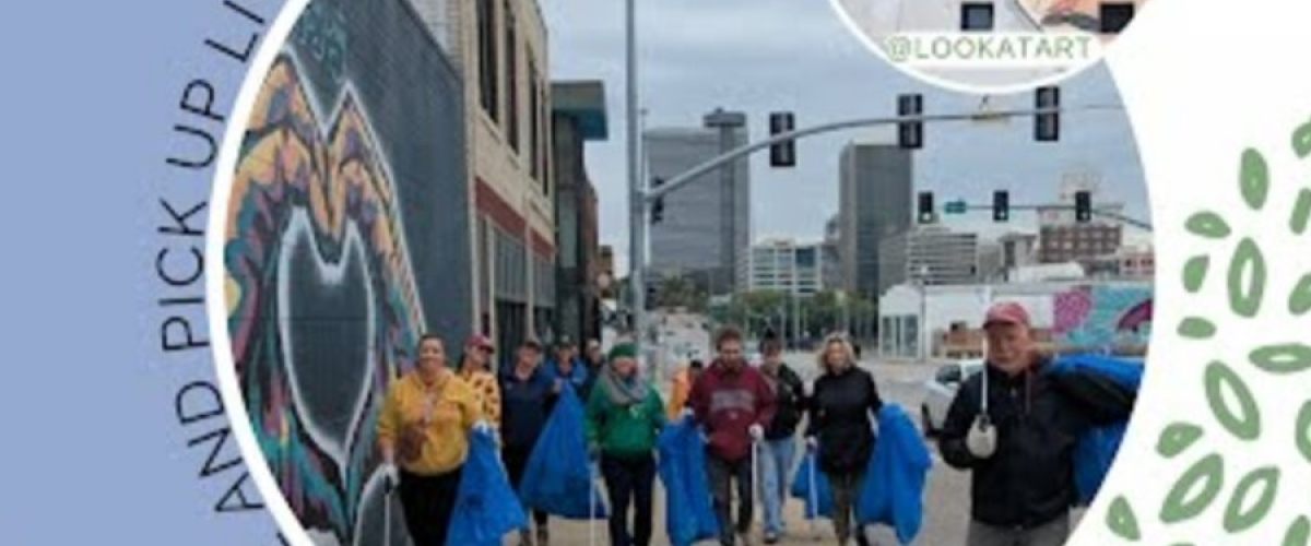Volunteers waking downtown with large blue trash bags and grabbers