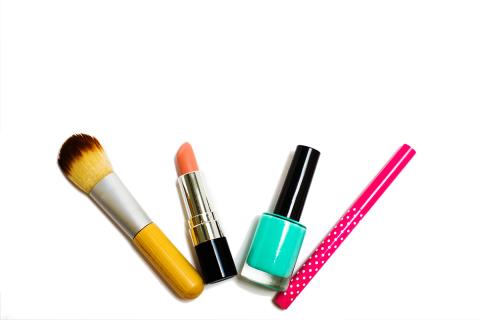 Makeup brush, lipstick, nail polish and a makeup product