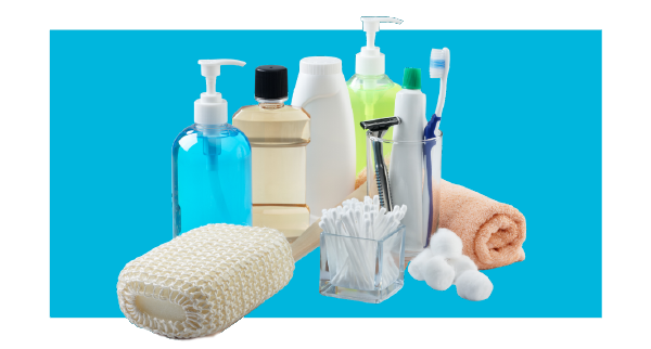 A variety of bathroom items, like soap, loofah and lotion, on a color background